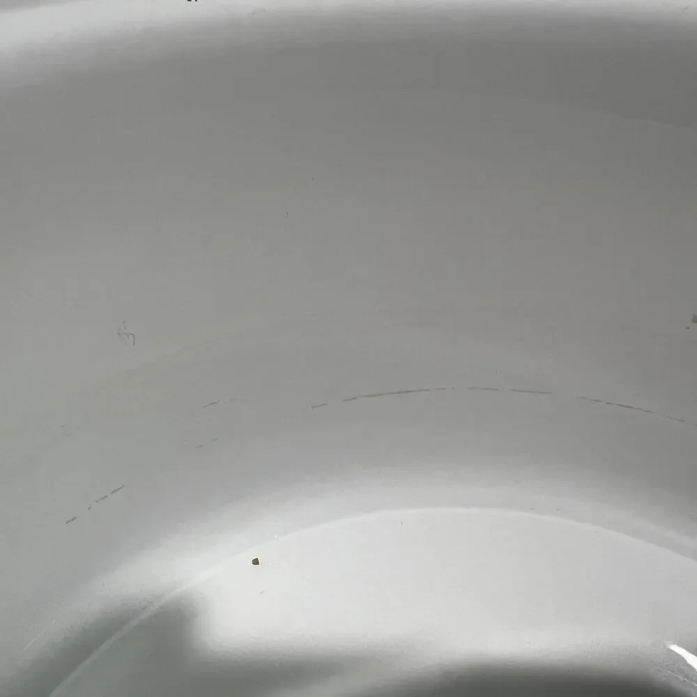 Enamel dog food or water bowl. Paw prints & bones adorn rim